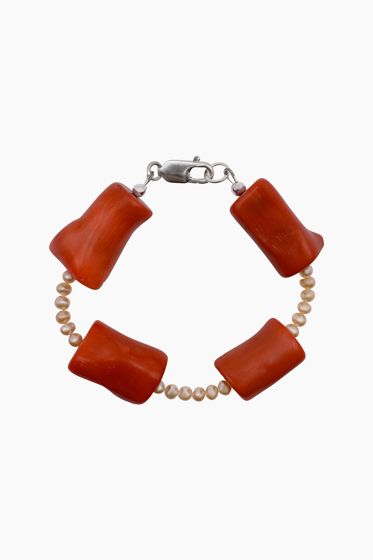 Close-up of the Coral Mini Bracelet featuring small freshwater baroque pearls and chunky coral beads. Ocean-inspired jewelry made from natural materials that honors the Earth.