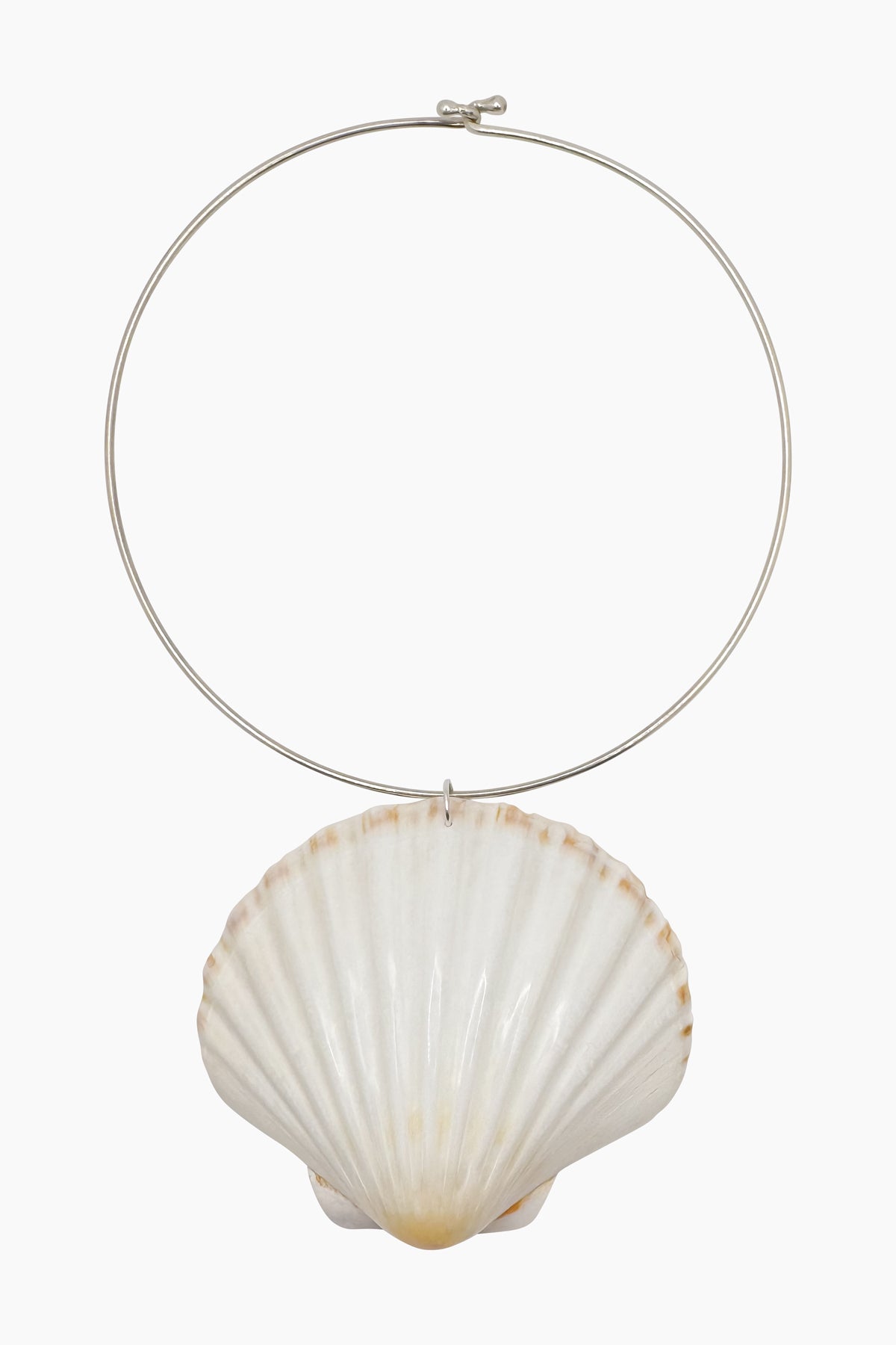 Product shot of the Marina Necklace, a sterling silver neck wire featuring a sculptural Irish scallop shell pendant.