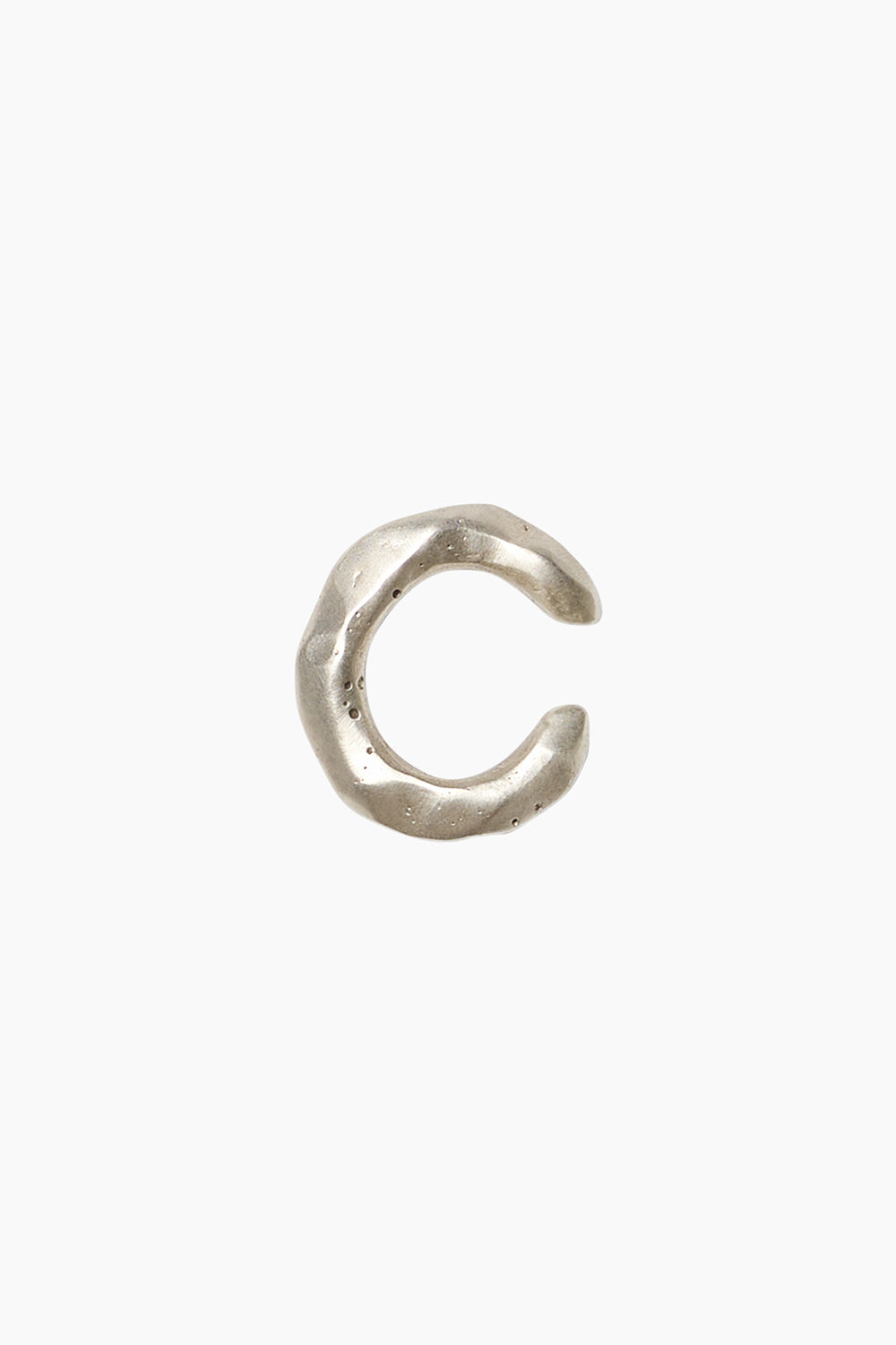 The Memento Ear Cuff — a textured sterling silver ear cuff with a hammered surface, adjustable fit.