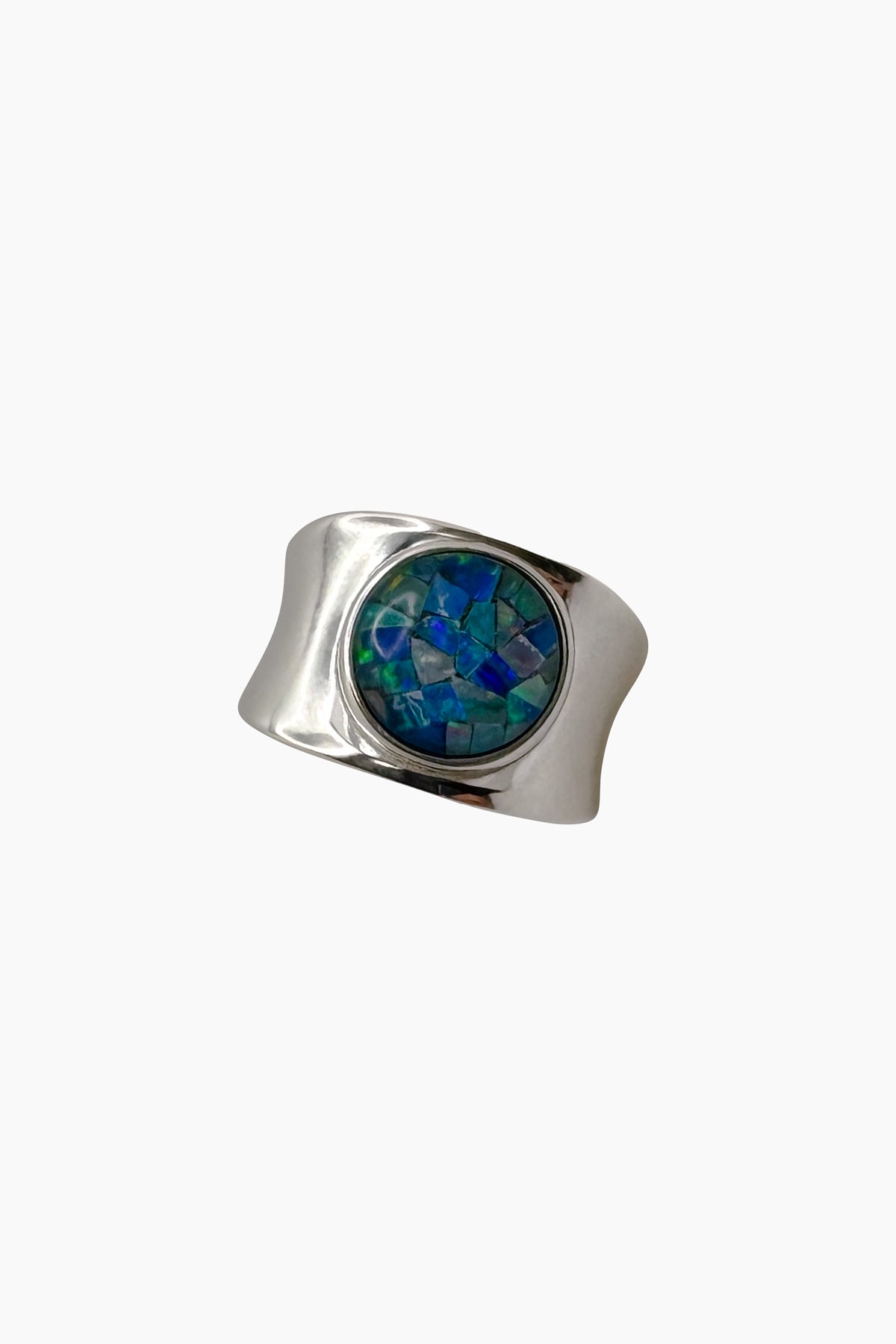 A chunky sterling silver concave ring set with a radiant opal mosaic cabochon, its colors reminiscent of the shifting hues of the ocean at dawn—subtle yet striking, handmade in Los Angeles.