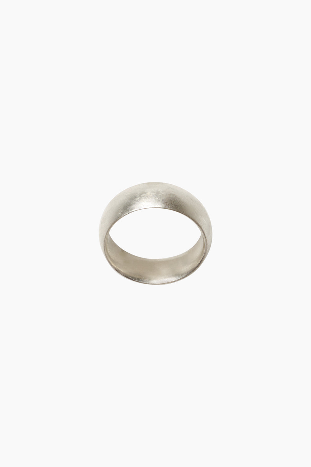 The Pact Ring — sterling silver cigar band ring shown from the side, highlighting its wide band profile and smooth contours.