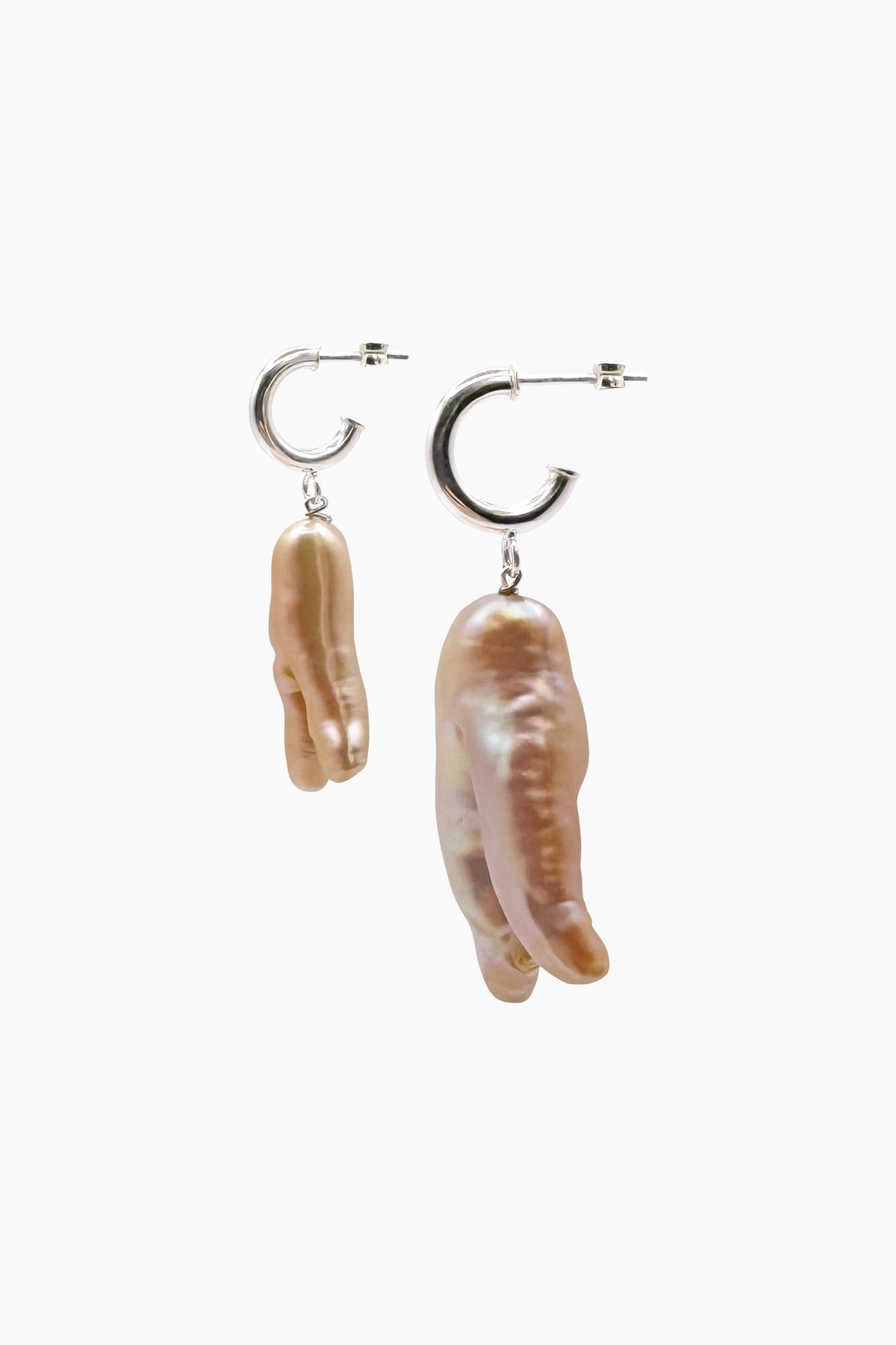 Side view of the Peggy earrings, featuring irregular freshwater pearls on sterling silver half hoops. This angle highlights the earring’s sculptural shape and organic texture.