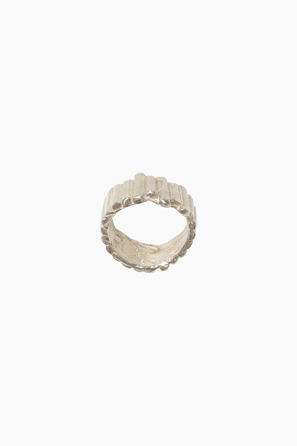 Side angle of the Relic Ring on a white background, highlighting its irregular band shape, sculptural texture, and organic ridged surface.