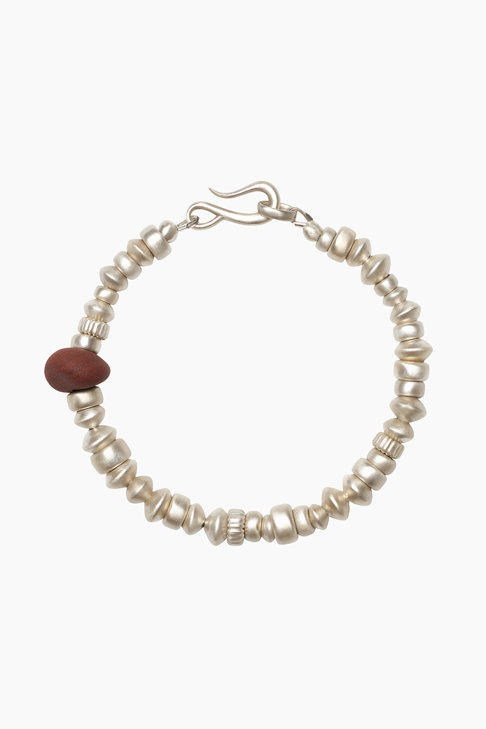 Remnant Bracelet — silver beads in irregular forms with a single red stone, photographed on a white background.