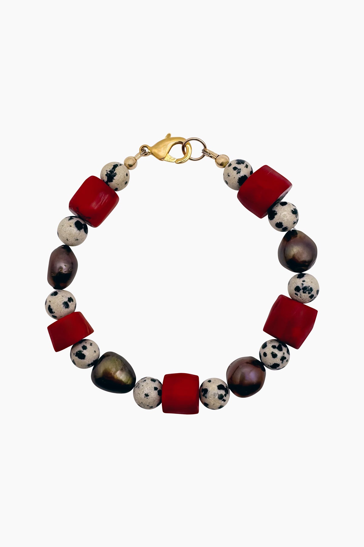 Sadie Bracelet product photo featuring coral, Dalmatian jasper, and freshwater pearl beads. Handmade beaded bracelet inspired by the natural elements of the ocean and the warmth of nature.
