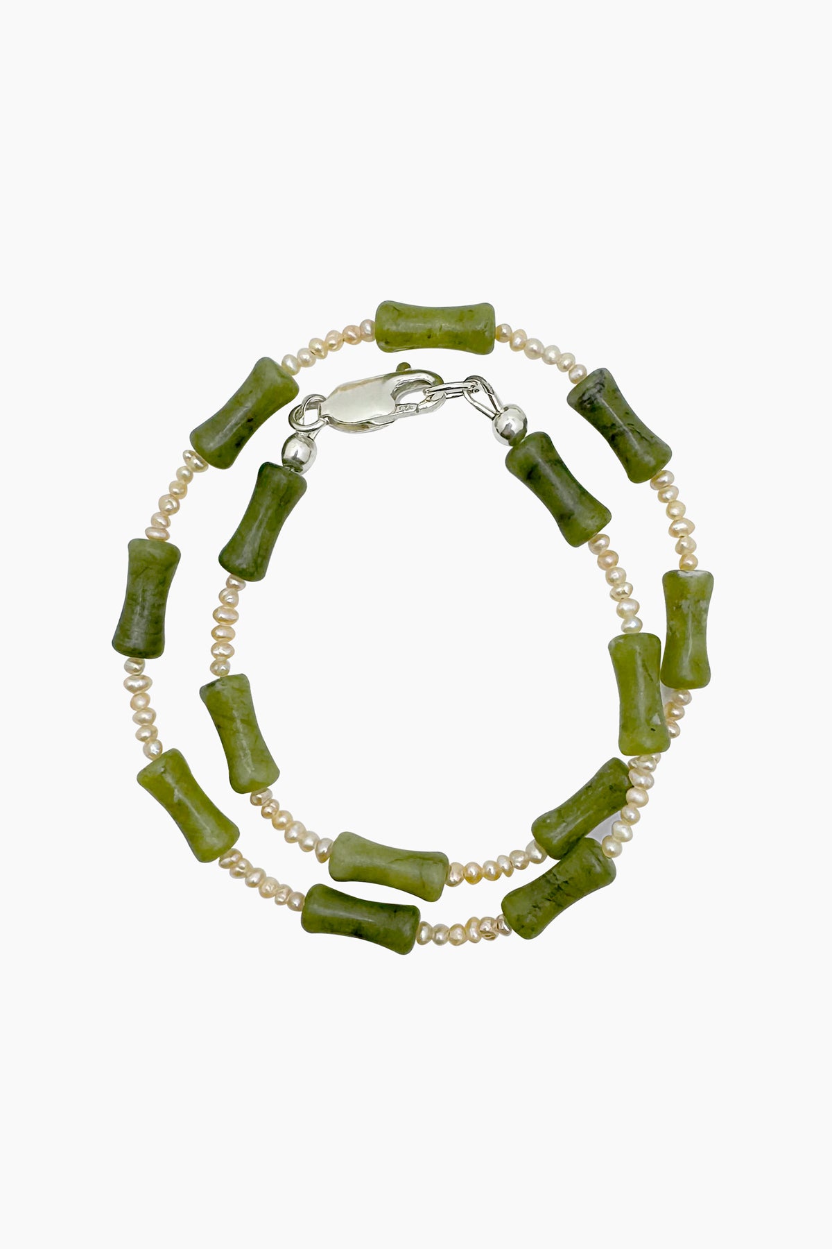 Close-up of the Santiago Bracelet, a handmade wrap bracelet crafted with serpentine and freshwater seed pearls, with a sterling silver lobster clasp.