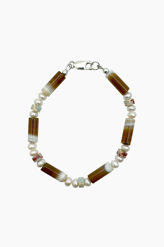 Close-up of the Bennie Bracelet, handcrafted with agate, jasper, and freshwater baroque pearls, with a sterling silver lobster clasp. 