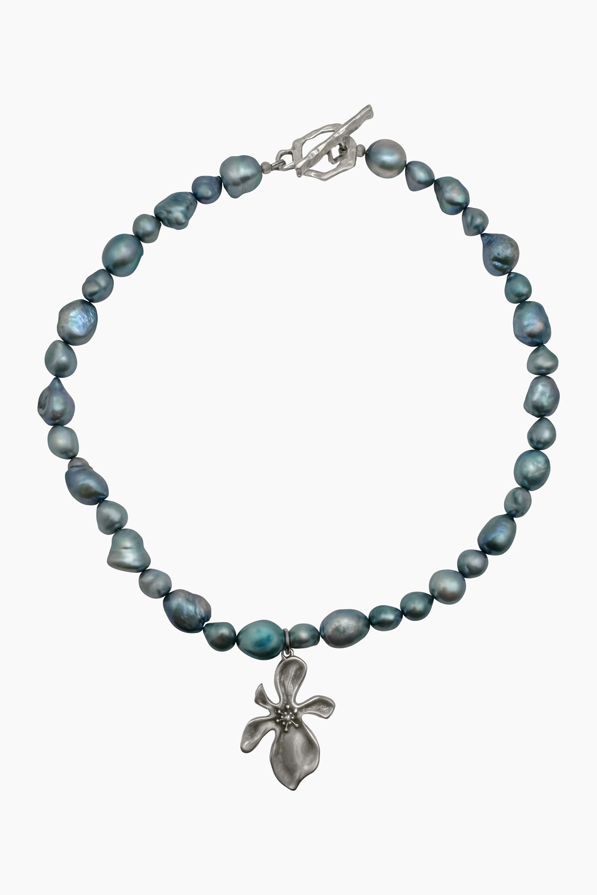 Product shot of the Cleo Necklace, featuring a chunky blue baroque pearl pendant on a sterling silver chain, with a sterling silver-plated hibiscus flower pendant. Nature-inspired jewelry with sculptural details.
