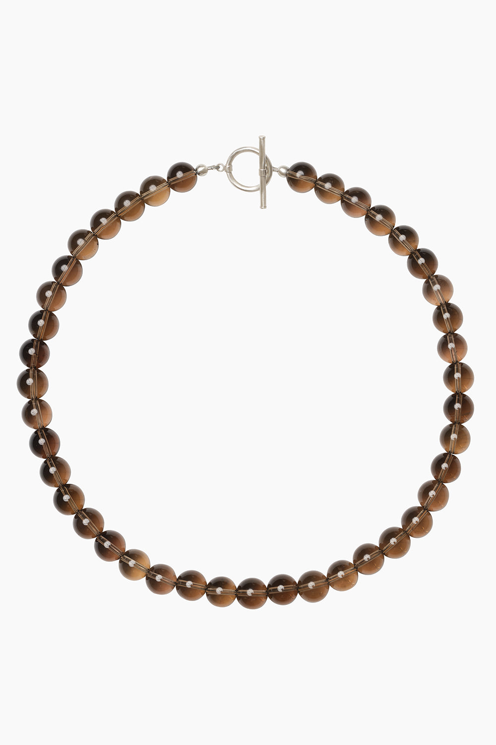 The Dusk Necklace — smoky quartz beads strung with a .925 sterling silver toggle clasp, photographed on white background.”