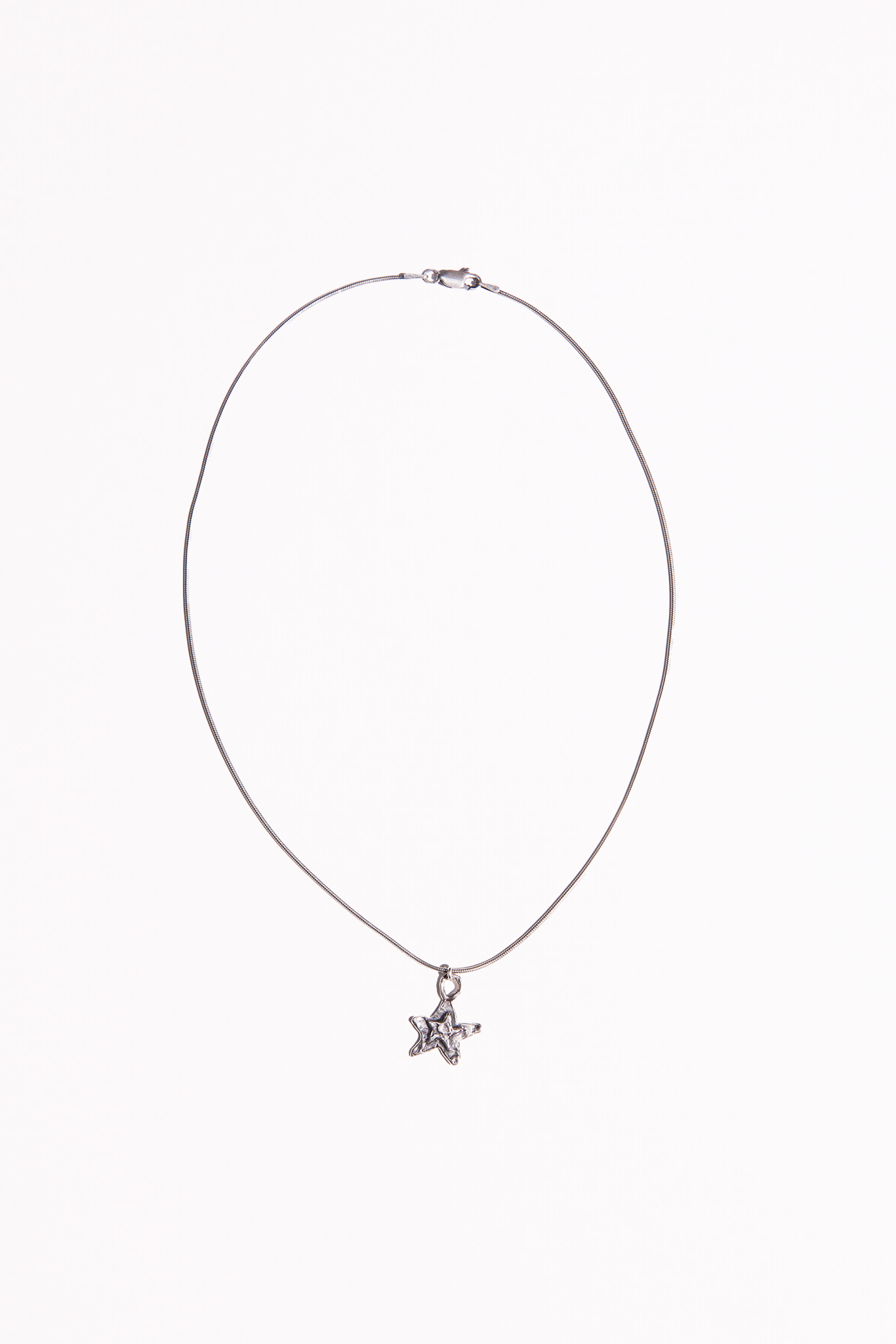 A Sterling Silver necklace featuring a hand cast star pendant.