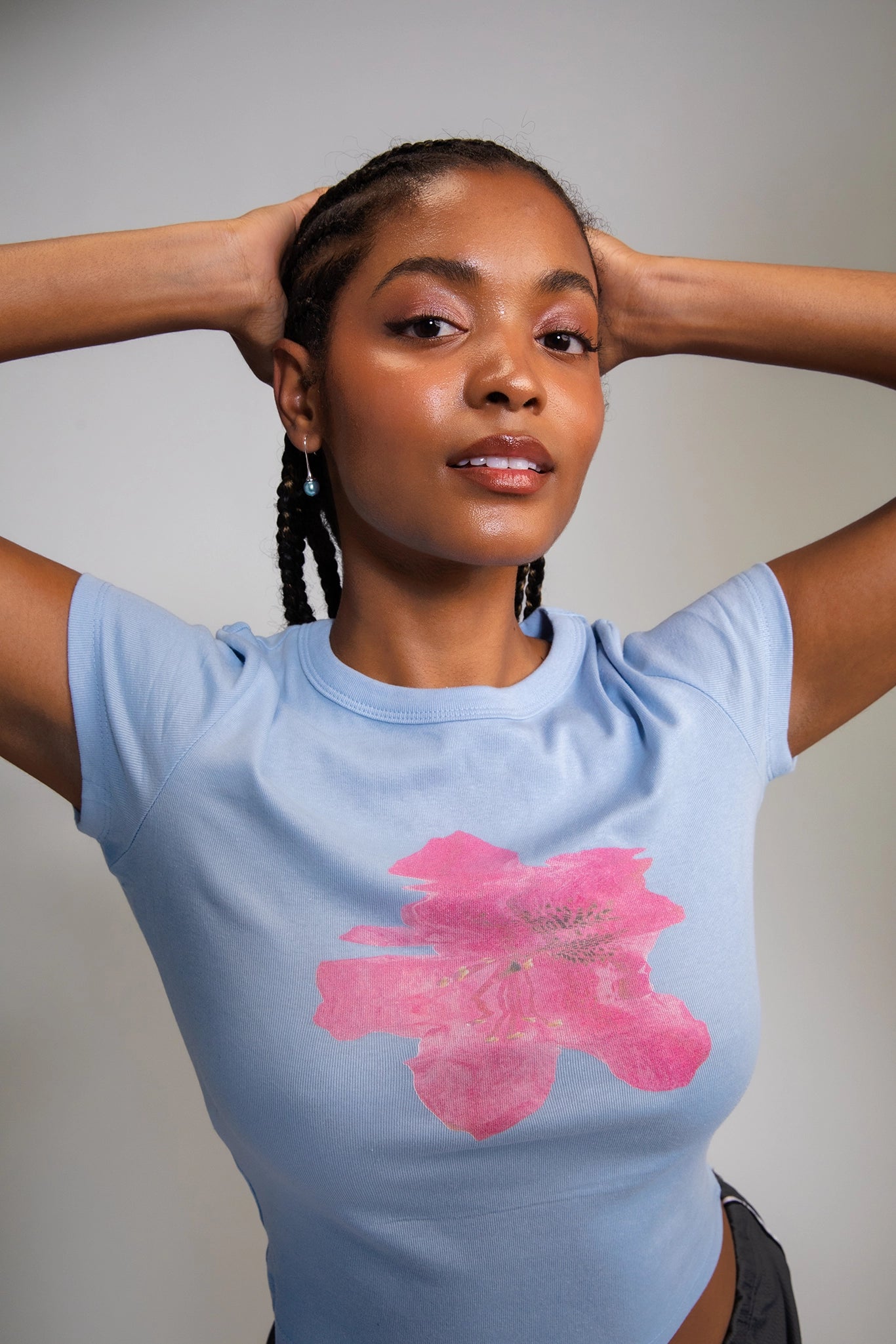 Fitted blue Tee with a hibiscus flower on it.