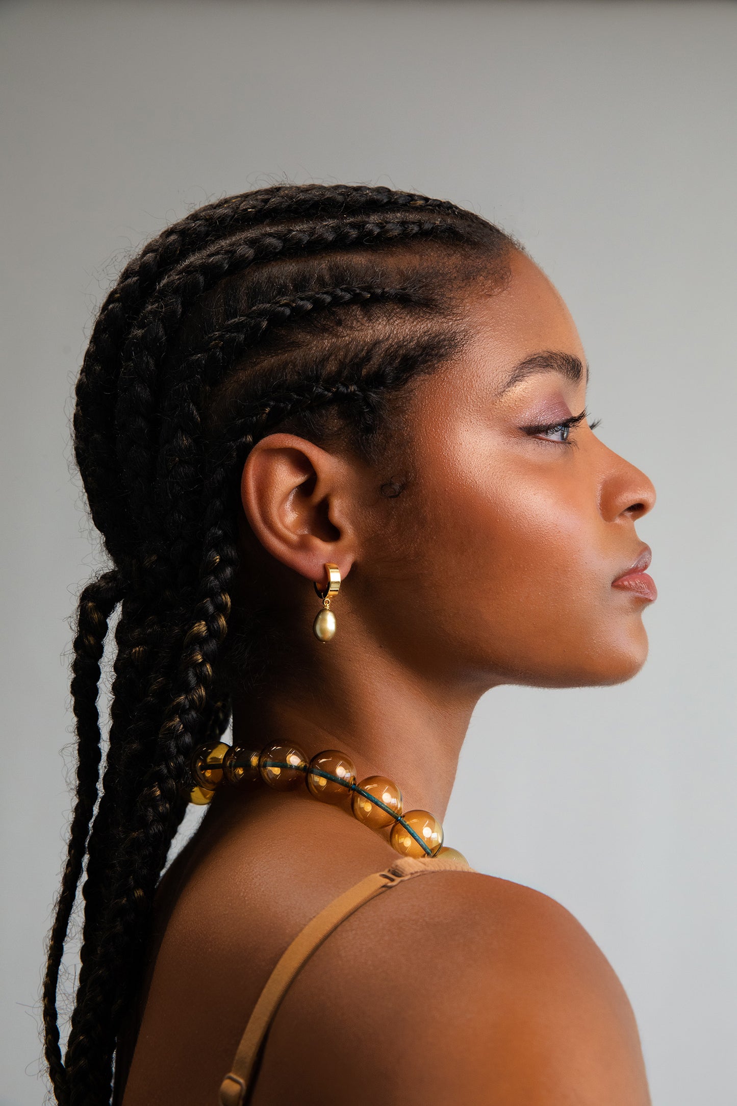 Model wearing green freshwater baroque pearl drops on 18K Gold Plated hoops.