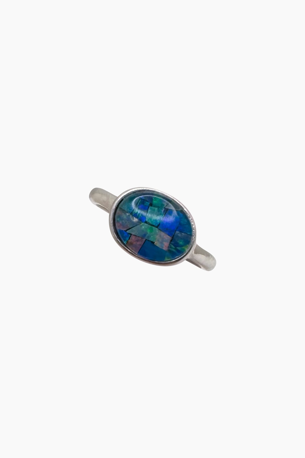 The Opal Mosaic I Ring, a stunning ocean-inspired oval ring featuring a radiant opal mosaic cabochon set in sterling silver, handmade with artisanal craftsmanship.