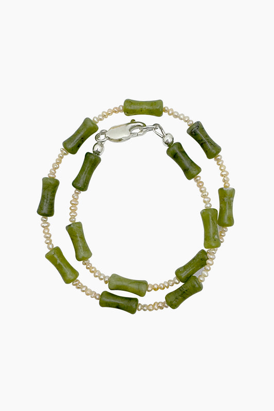 Close-up of the Santiago Bracelet, a handmade wrap bracelet crafted with serpentine and freshwater seed pearls, with a sterling silver lobster clasp. 