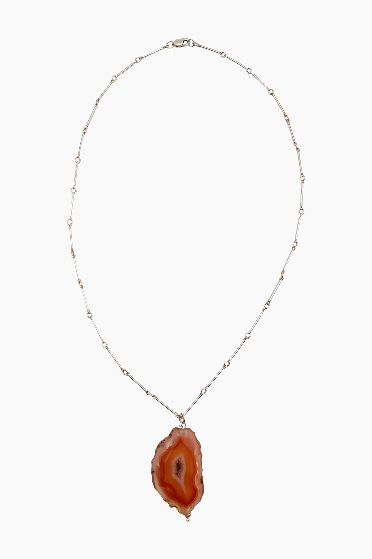 Product shot of the Sol Necklace featuring a sterling silver straight bar and link chain with a Condor Agate pendant. Nature-inspired design rooted in modern minimalism.
