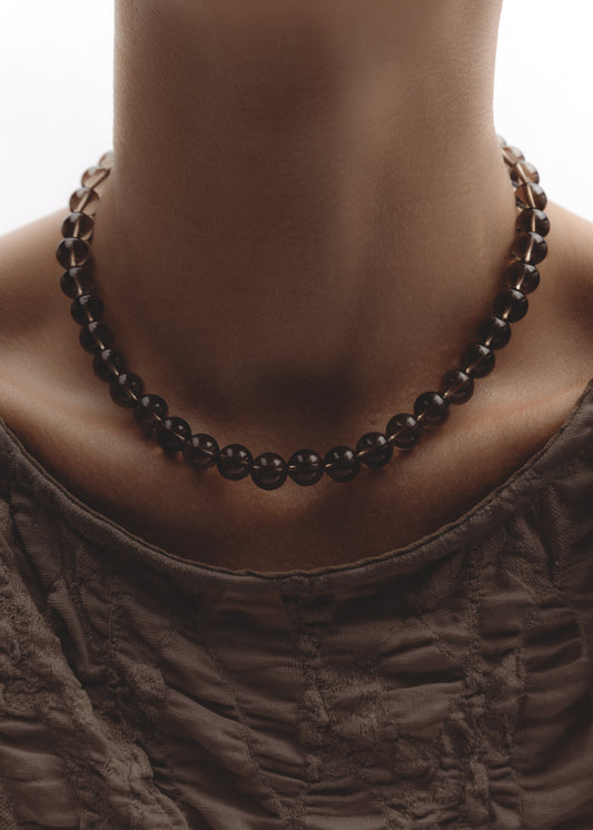 Model wearing the Dusk Necklace — smoky quartz beaded necklace finished with a .925 sterling silver toggle clasp.
