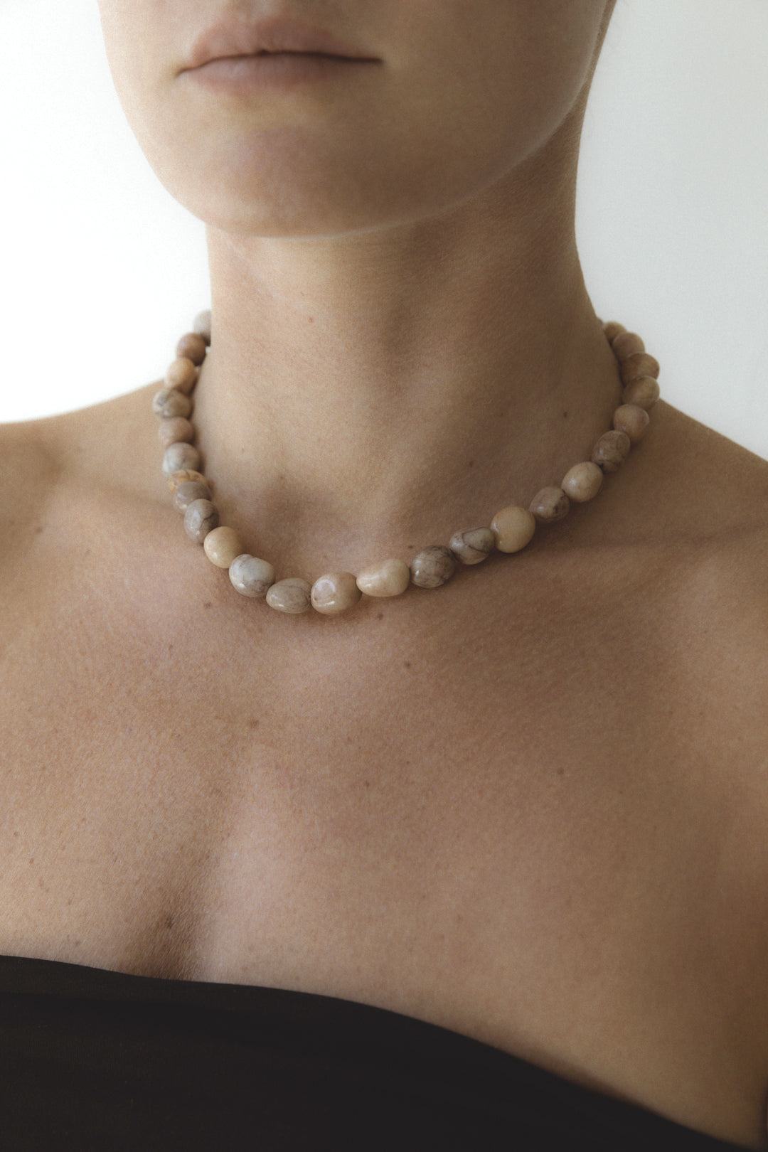 The Strata Necklace by cocoatemyshoes — a handcrafted stone necklace made from smooth honey jasper, combining natural form and tactile texture.