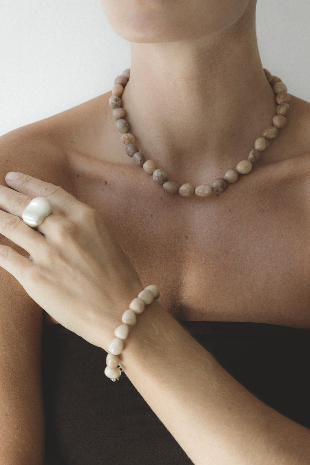 Model wearing The Strata Necklace by cocoatemyshoes, paired with The Token Bracelet and The Vessel Ring — an organic, chunky sterling silver statement ring. A sculptural, boho look with a vintage feel.