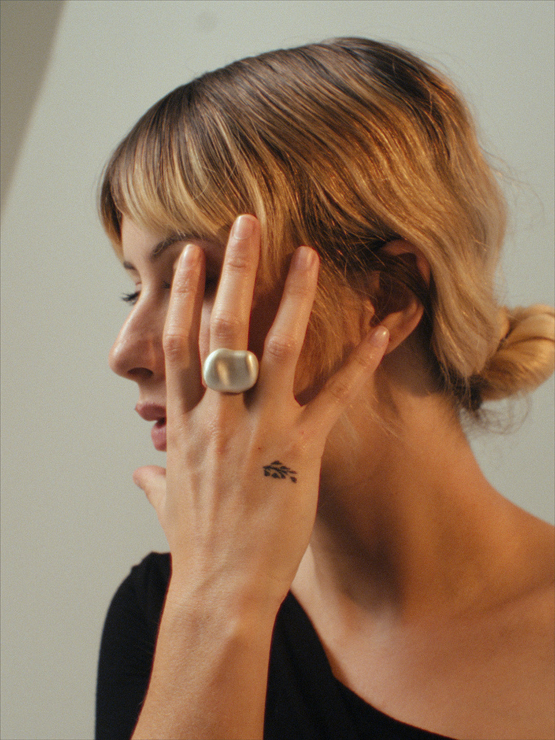 The Vessel Ring by cocoatemyshoes — a sculptural sterling silver statement ring with a soft dome shape and matte texture, shown in warm light highlighting its organic, tactile surface.