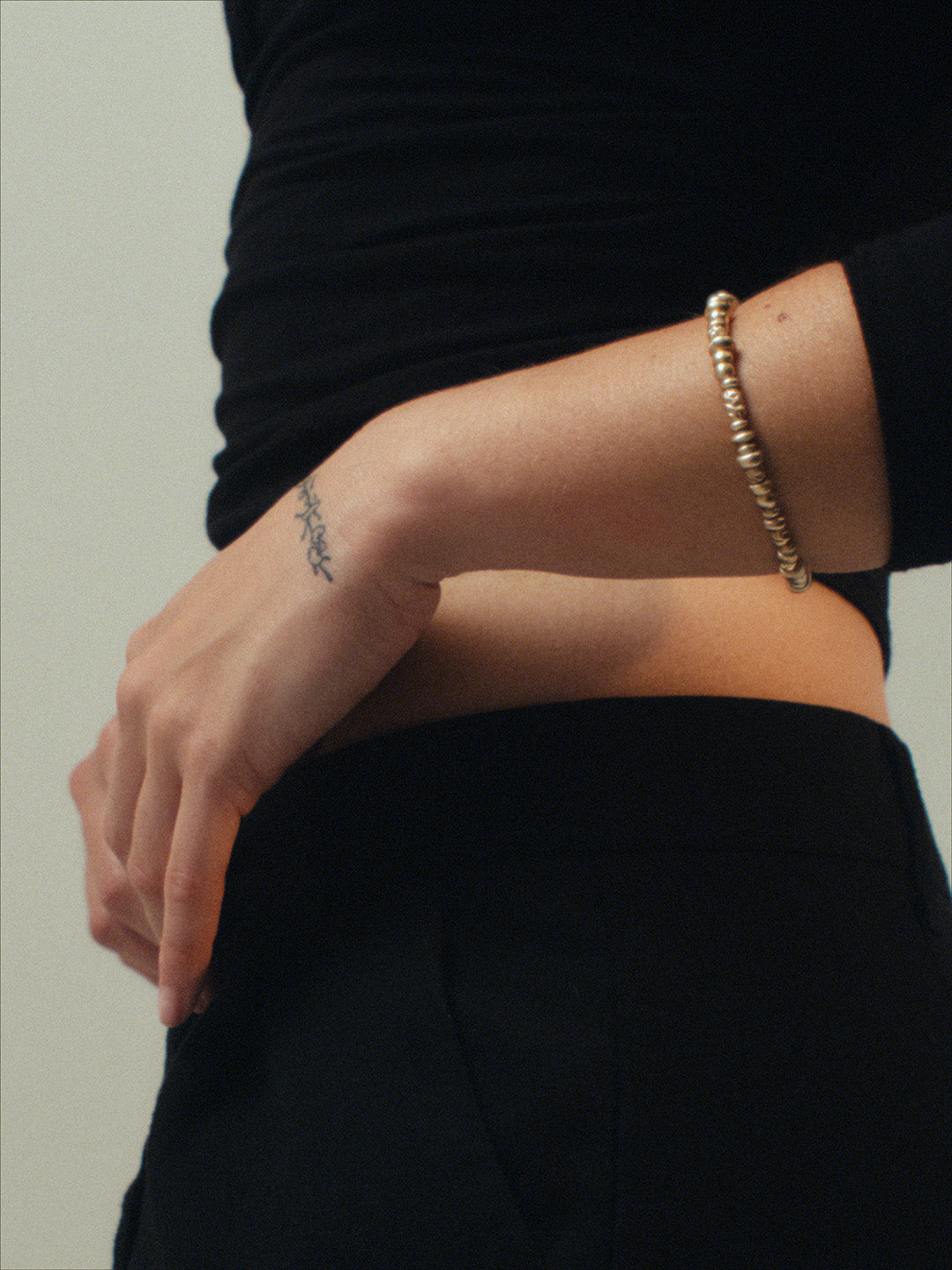The Votive Bracelet handcrafted by cocoatemyshoes — a gold-filled beaded bracelet in soft, irregular forms, shown on the wrist with a gentle, tactile presence.