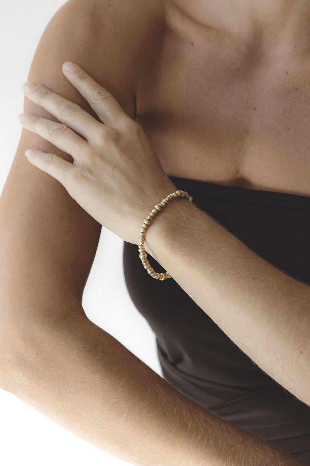 The Votive Bracelet by cocoatemyshoes — a gold beaded bracelet that bridges modern design and vintage sentiment, worn alone or stacked as a quiet statement.