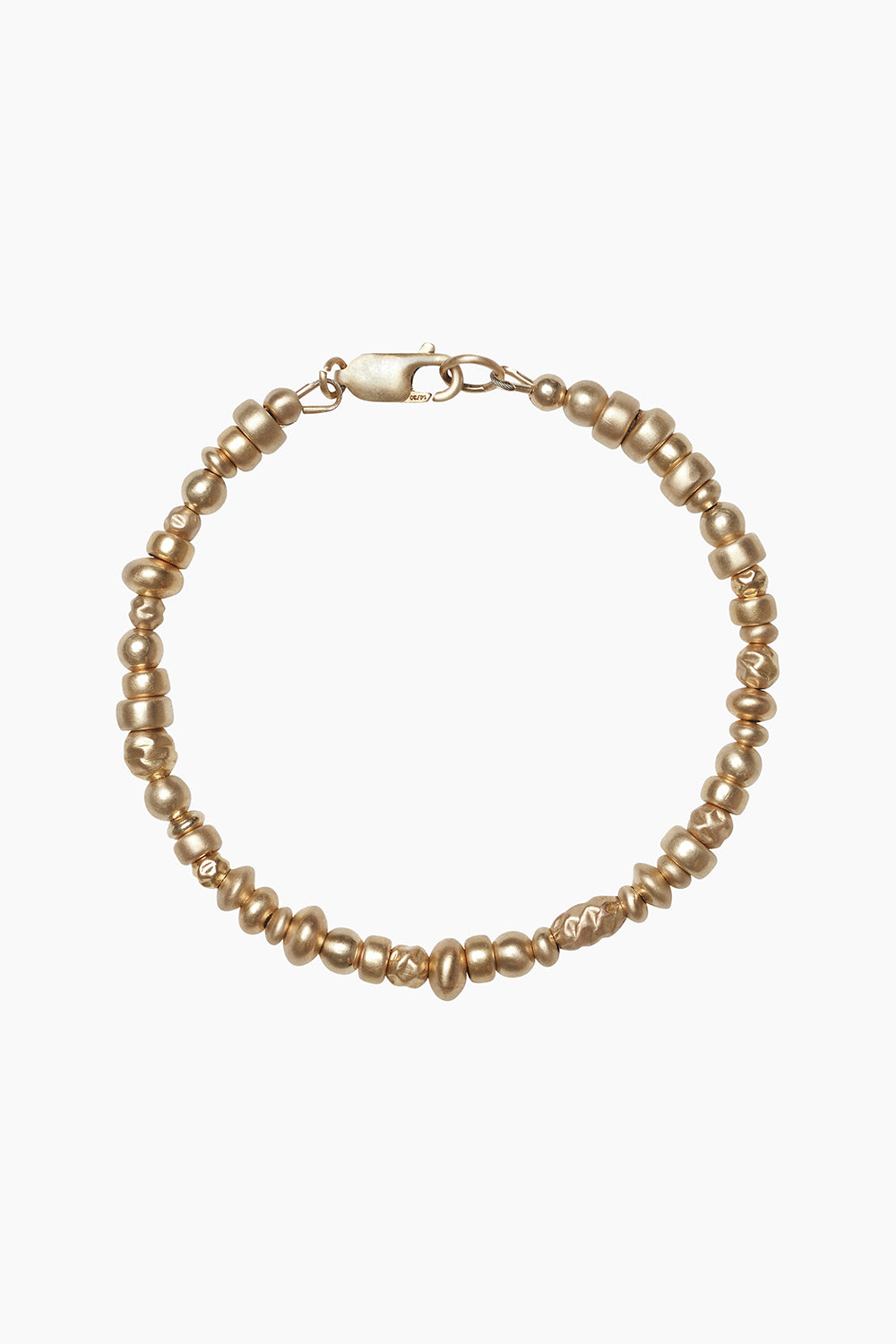 The Votive Bracelet by cocoatemyshoes — detailed view of 14k gold-filled beads in irregular, hand-shaped forms, photographed on a neutral background to highlight their subtle sheen and modern heirloom feel.